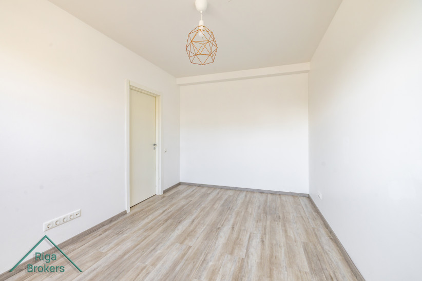 Minimalist bedroom with door and light walls