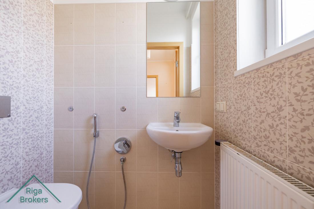 Compact bathroom with sink and mirror
