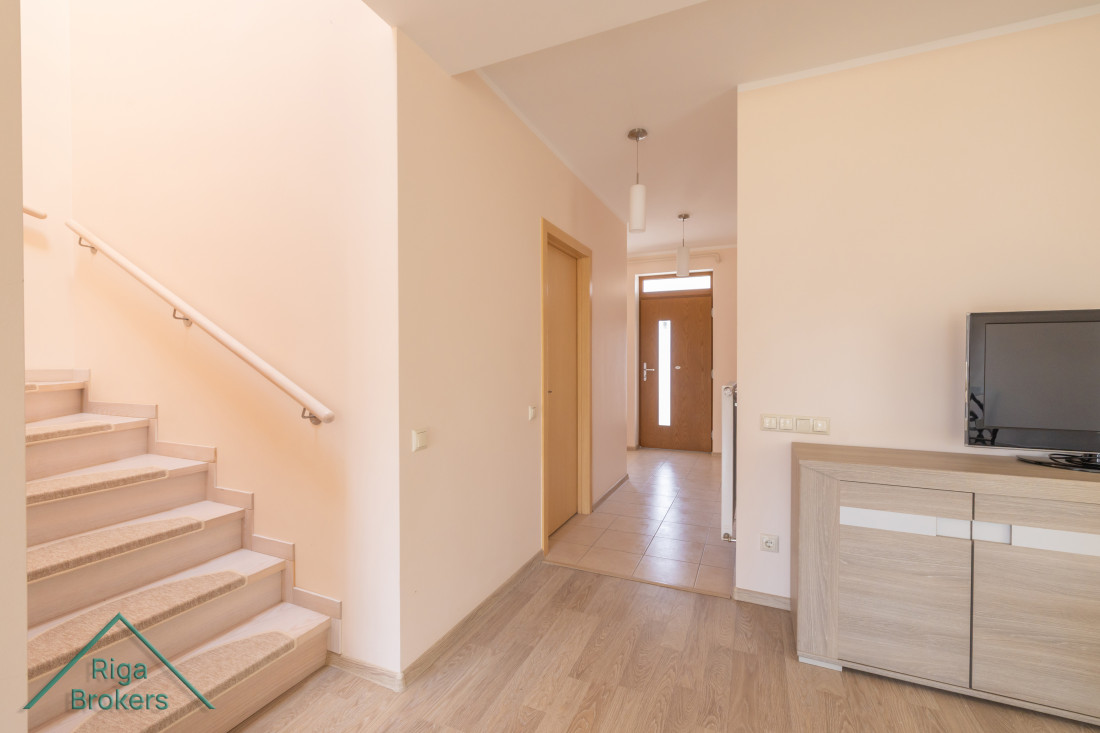 Bright hallway with wooden staircase