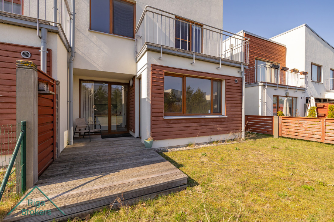Wooden terrace with seating by house