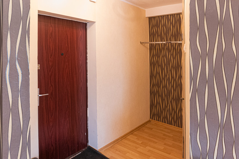 Entrance hall with wooden door and hanger