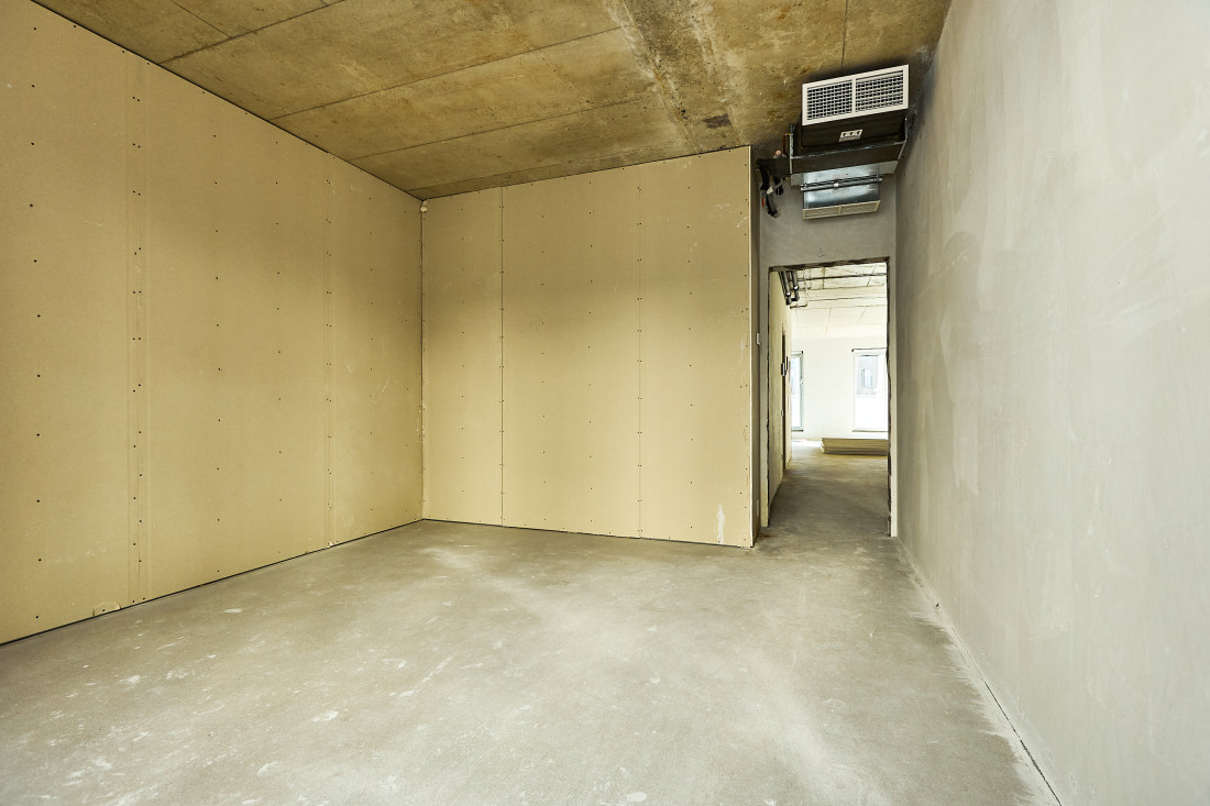Spacious room with wooden wall panel.
