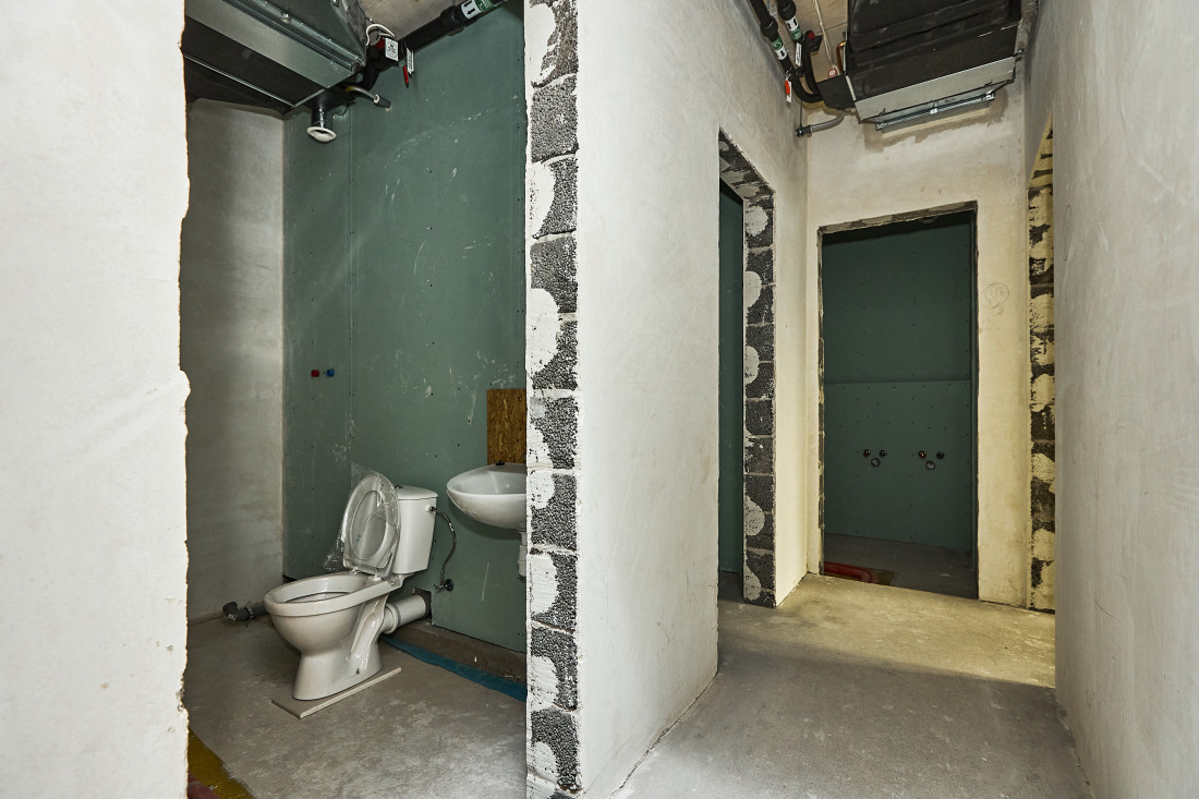 Toilet and sink in construction stage.