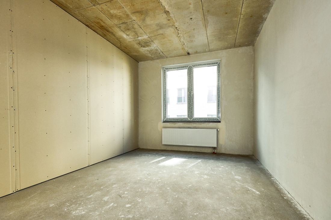 Small room with window and radiator.