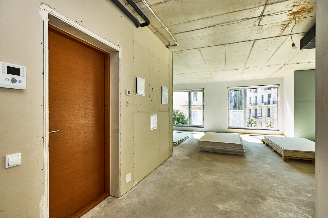 Unfinished room with wooden door.