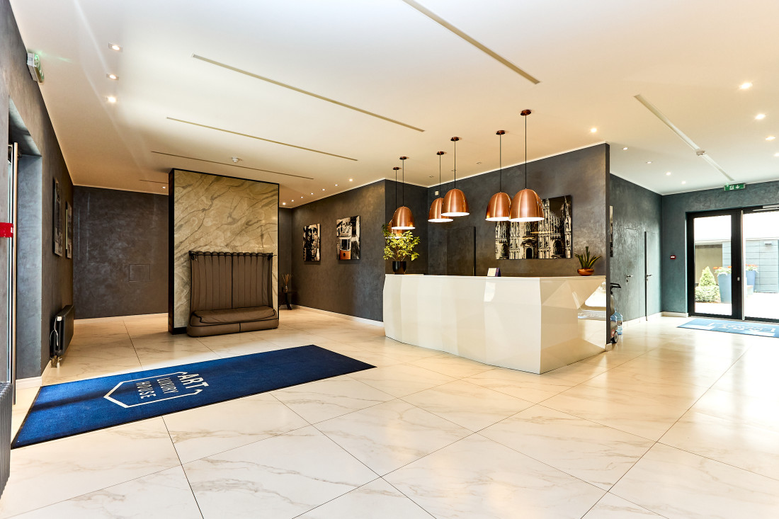 Spacious reception area with copper lamps.
