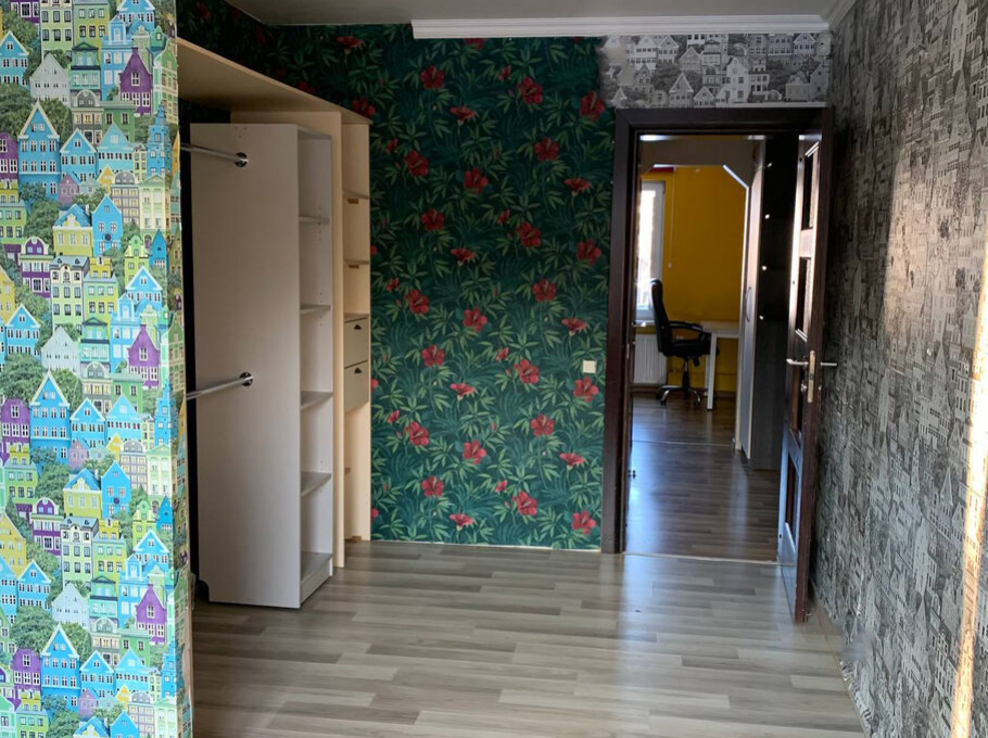 Room with colorful and varied wallpapers.