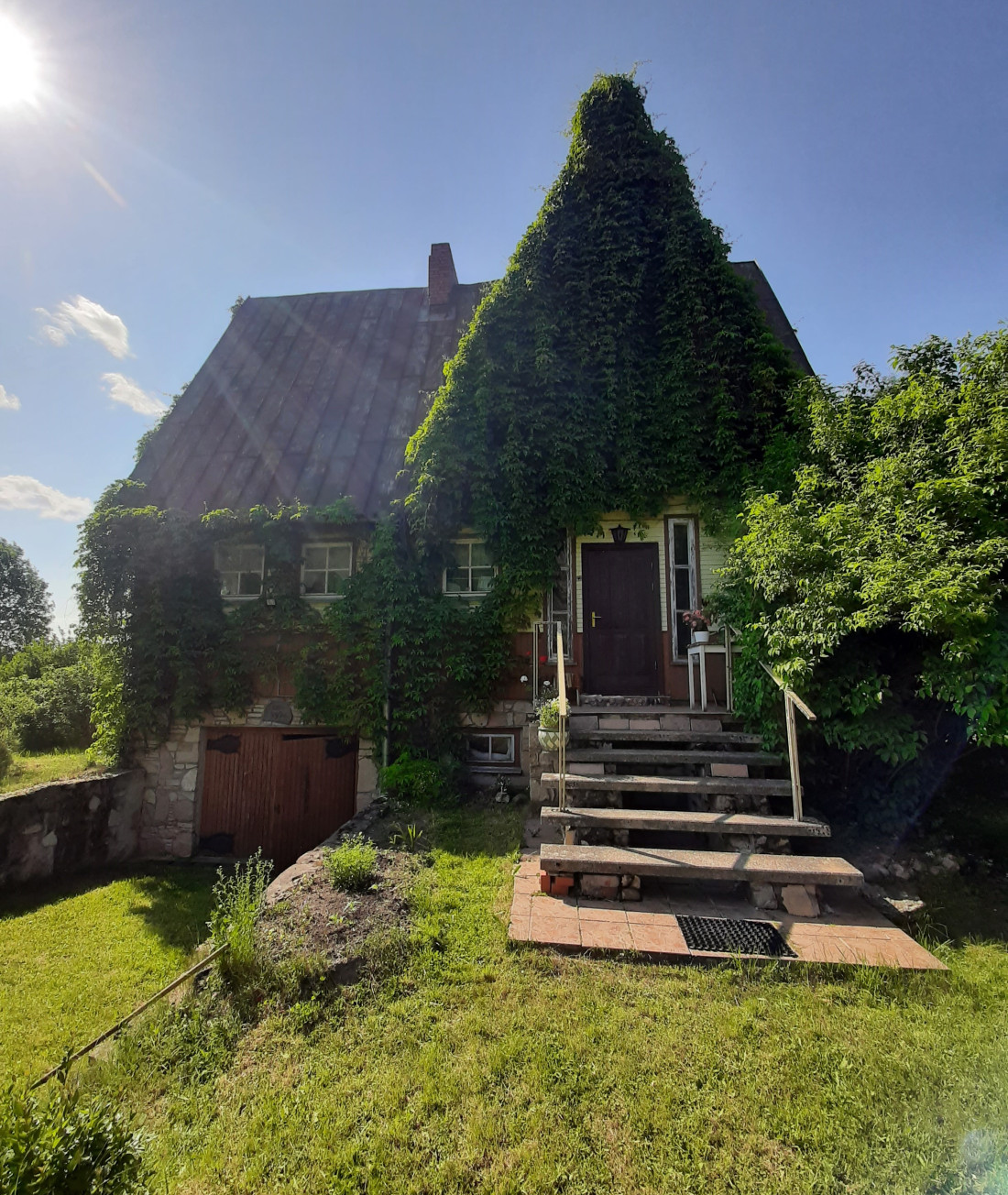 Brick house with stairs and a pavilion.