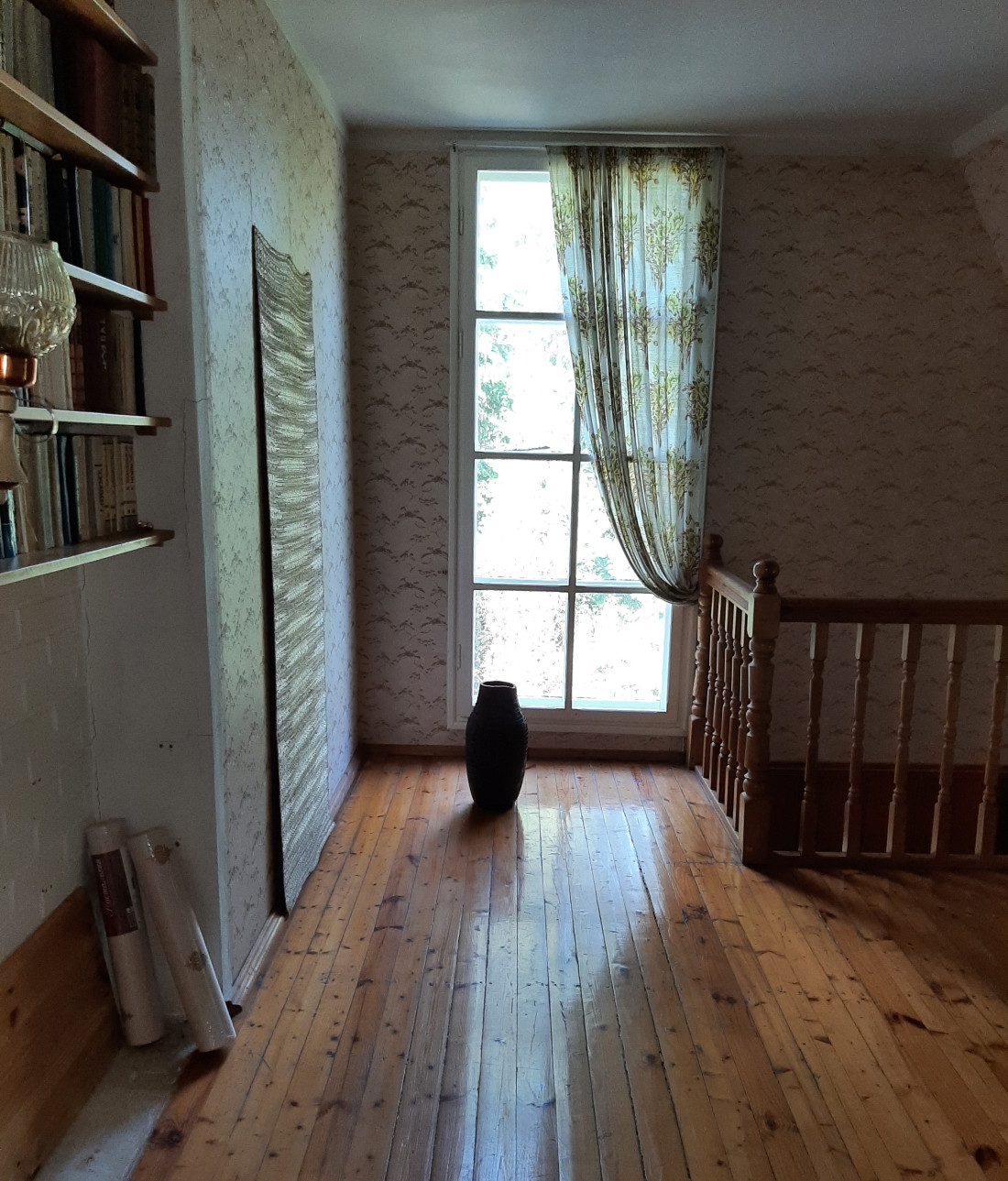 Window with curtains and vase indoors.