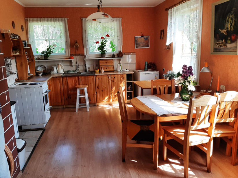 Dining room with wooden furniture and windows.
