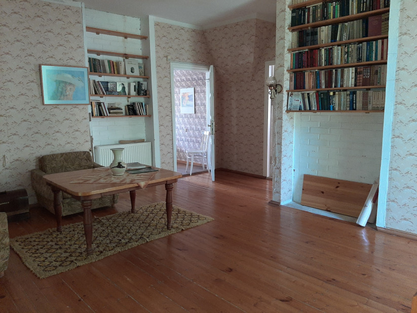 Room with bookshelves and a table.