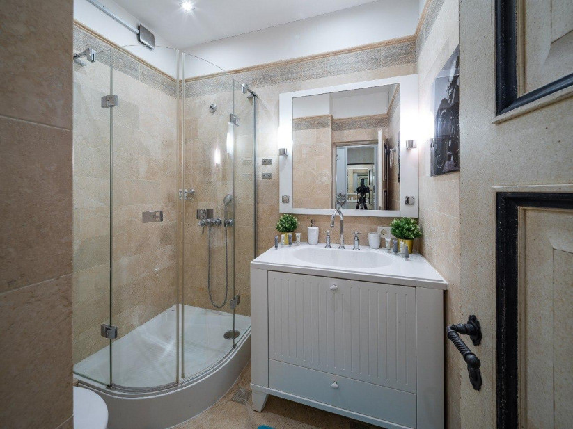 Modern bathroom with shower and mirror.