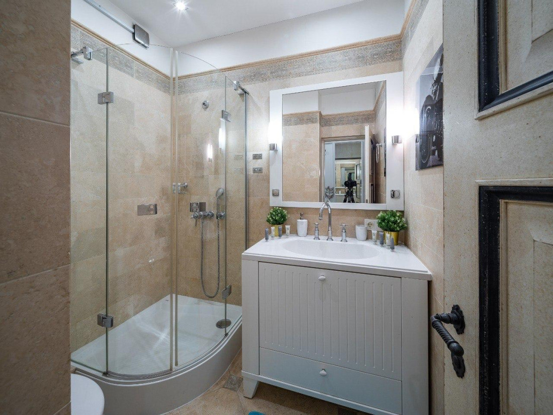 Modern bathroom with shower and mirror.