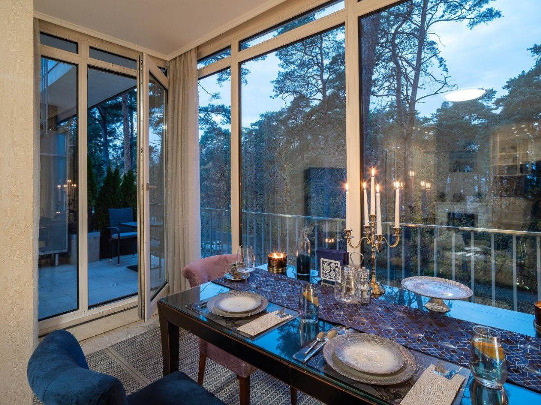 Dinner table view with forest backdrop.