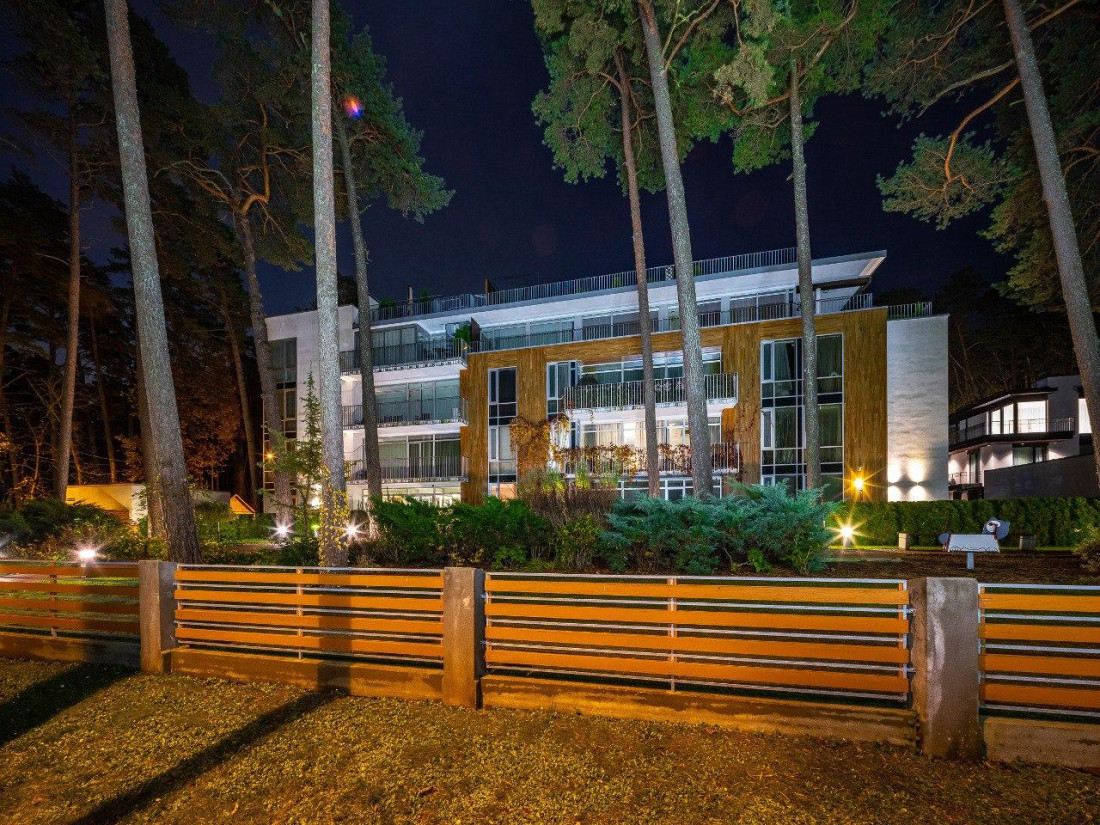 Modern apartment facade with evening lights.