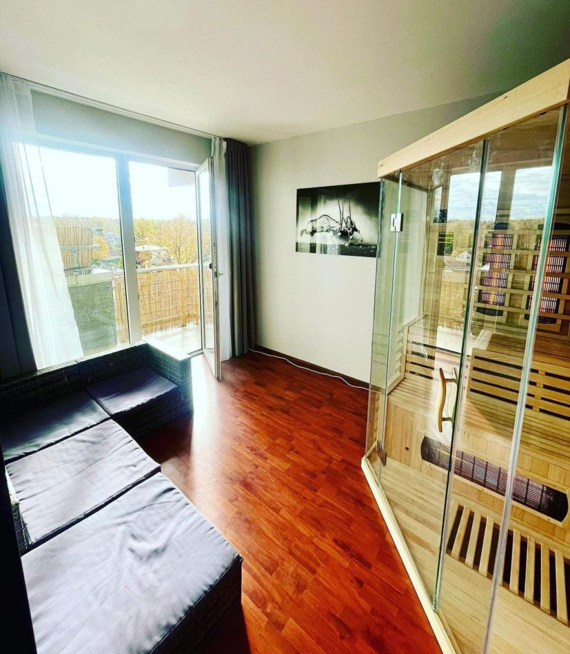 Room with glass sauna and balcony.