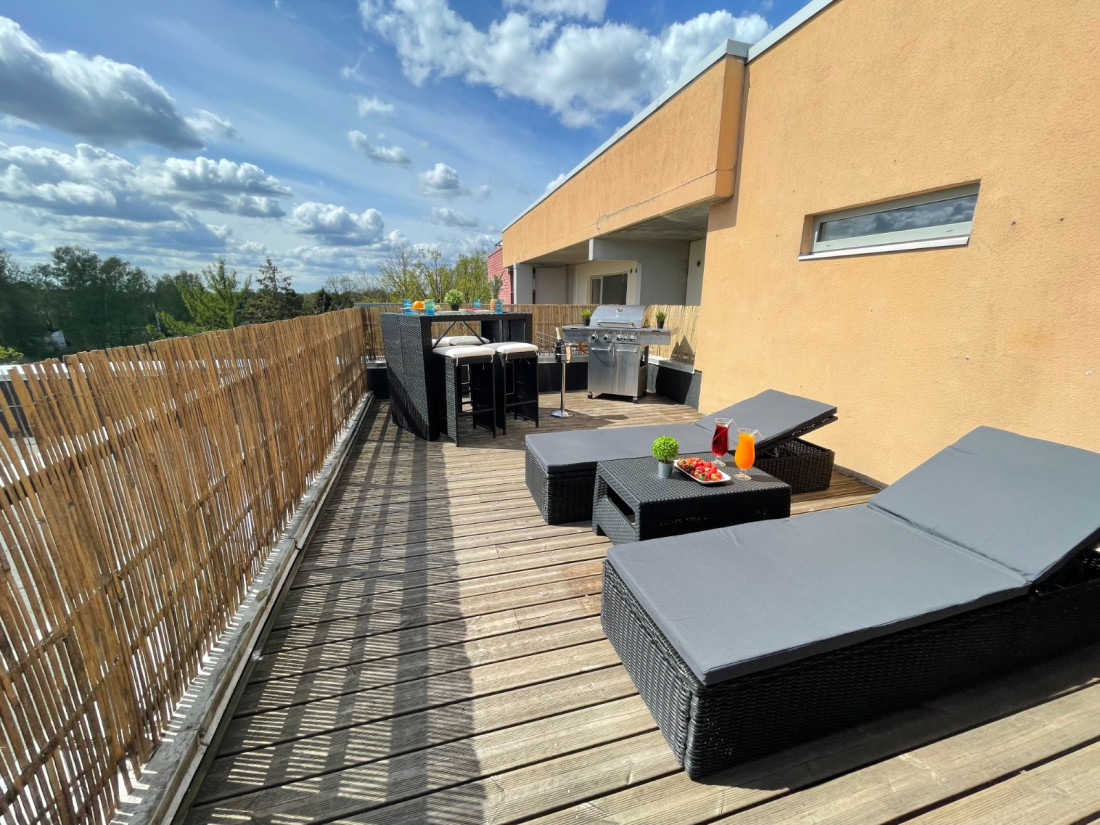 Sunny terrace with lounge chairs.