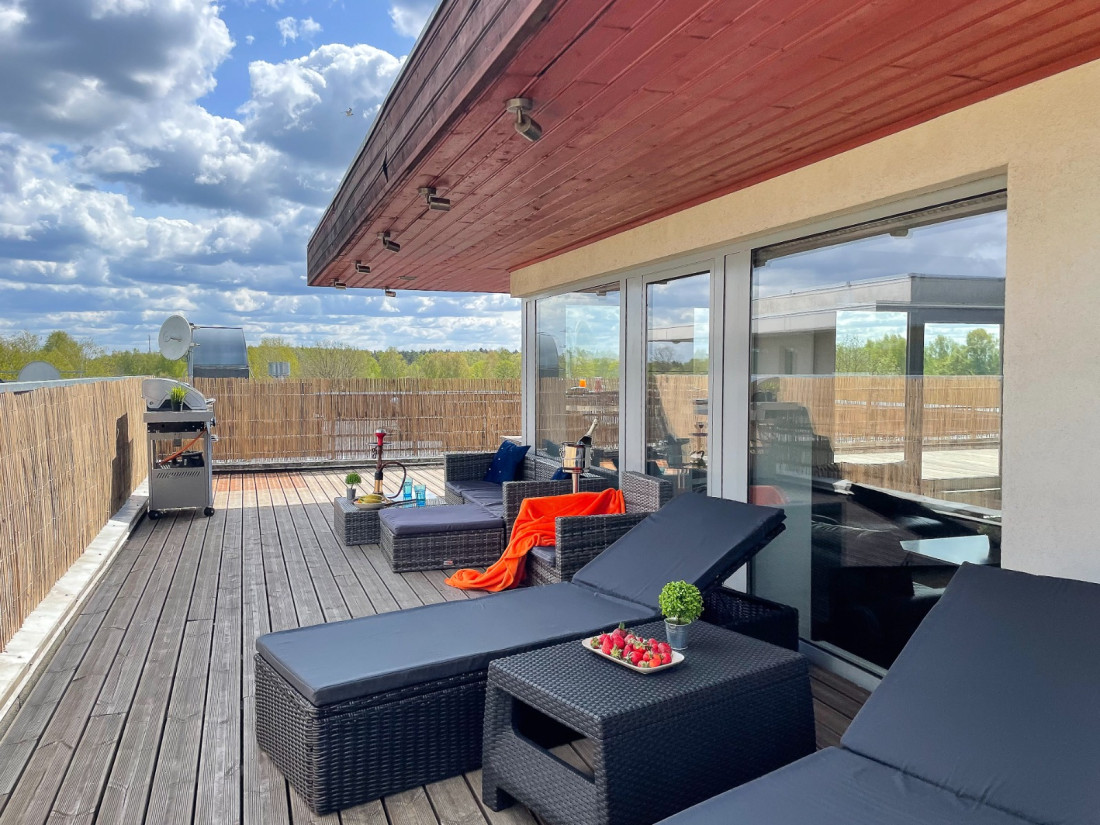 Outdoor terrace with black furniture.