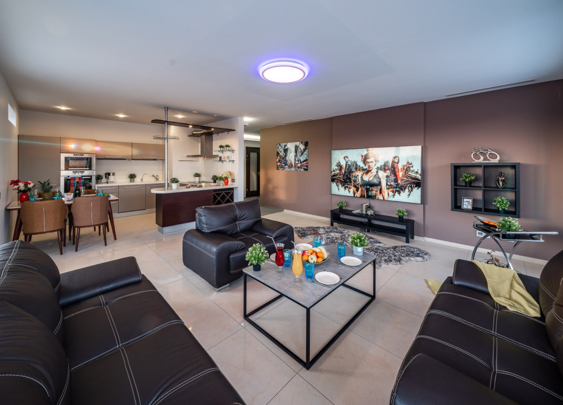 Living room with leather furniture and TV.