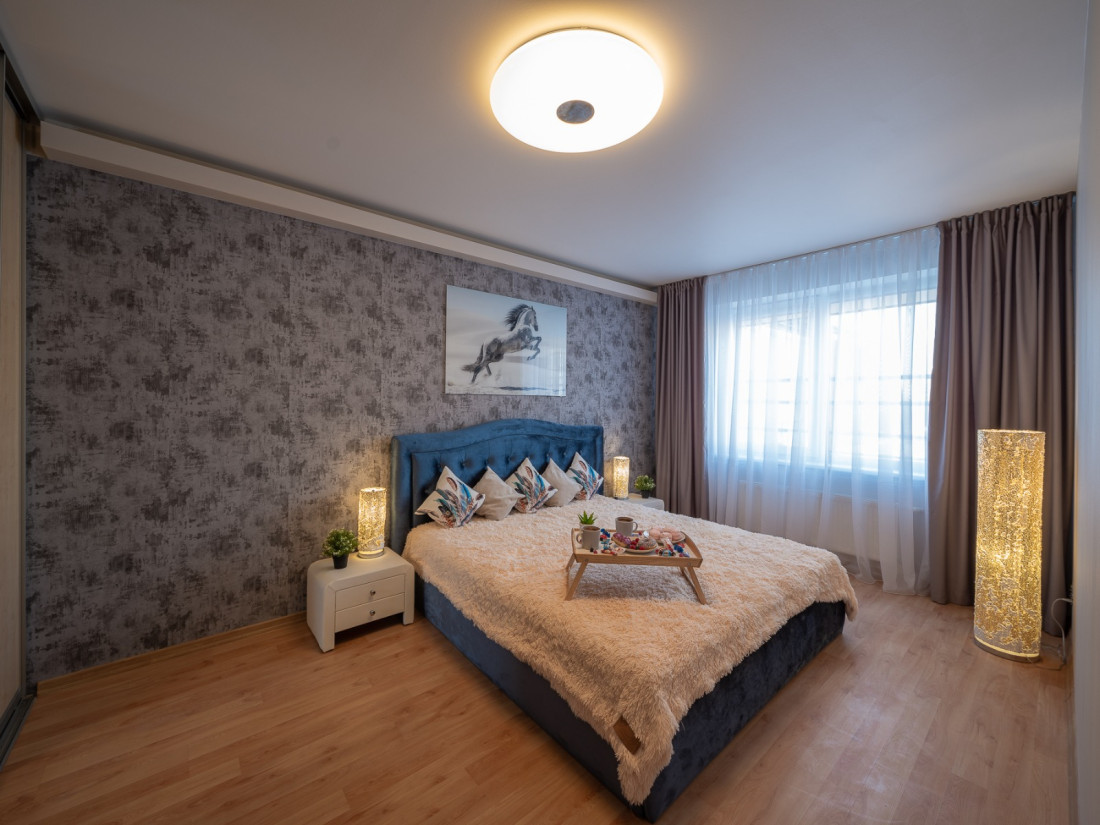 Bedroom with plush bed and breakfast tray.