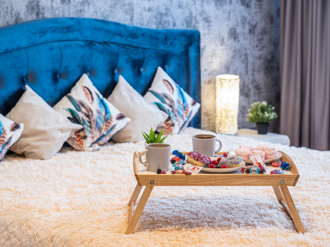 Bed with vibrant blue headboard.