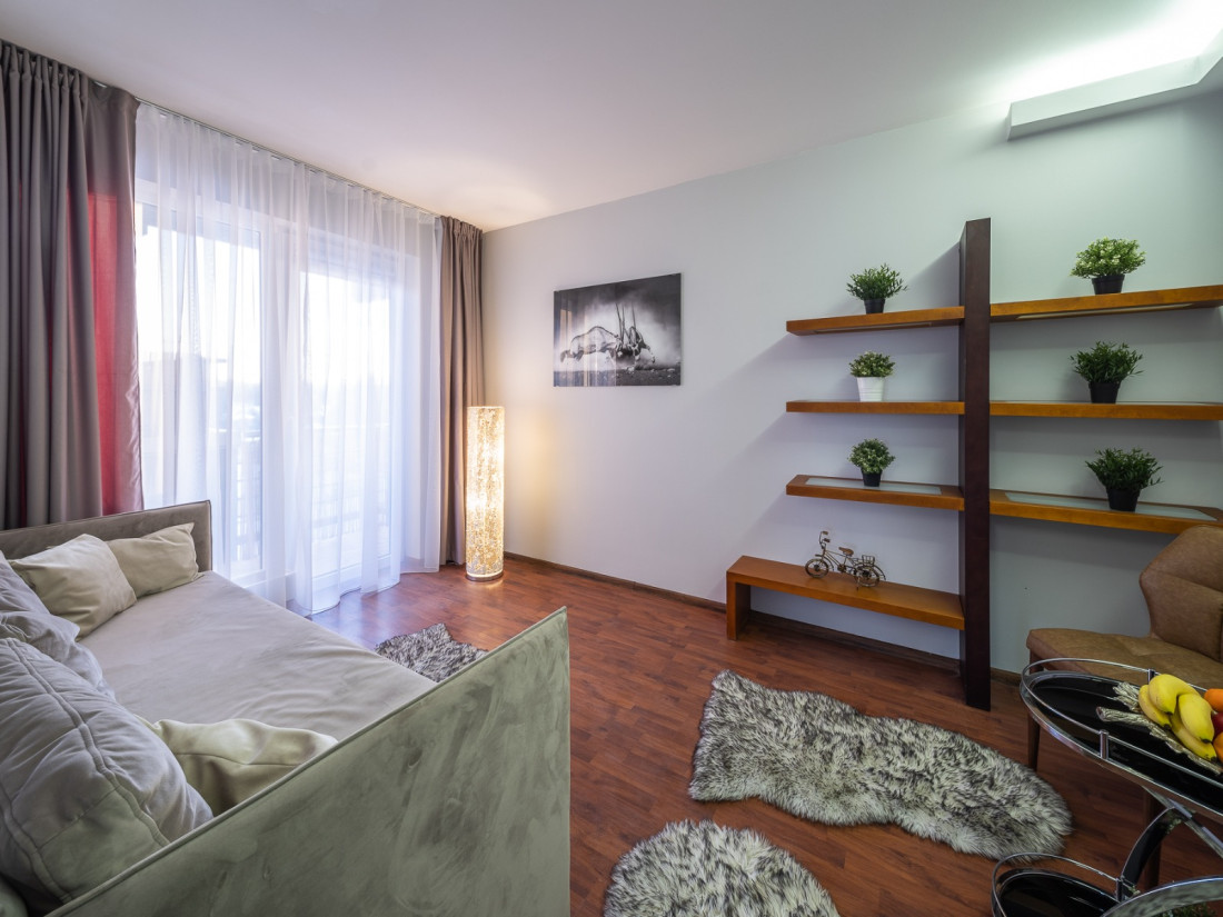 Lounge with shelves and a sofa.
